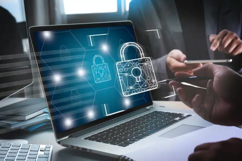 Digital lock icon on laptop screen representing AI content protection, anti-scraping measures, and copyright control for publishers in 2025 against unauthorized AI data collection.